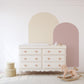 a baby's room with a rocking horse and a dresser