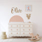 a baby's room with a white dresser and a pink rocking horse
