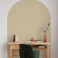 neutral oat colored arch in a contemporary office space with a velvet chair.