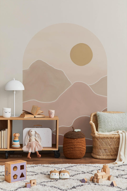 A muted pink wall decal that features a painted look with a setting sun